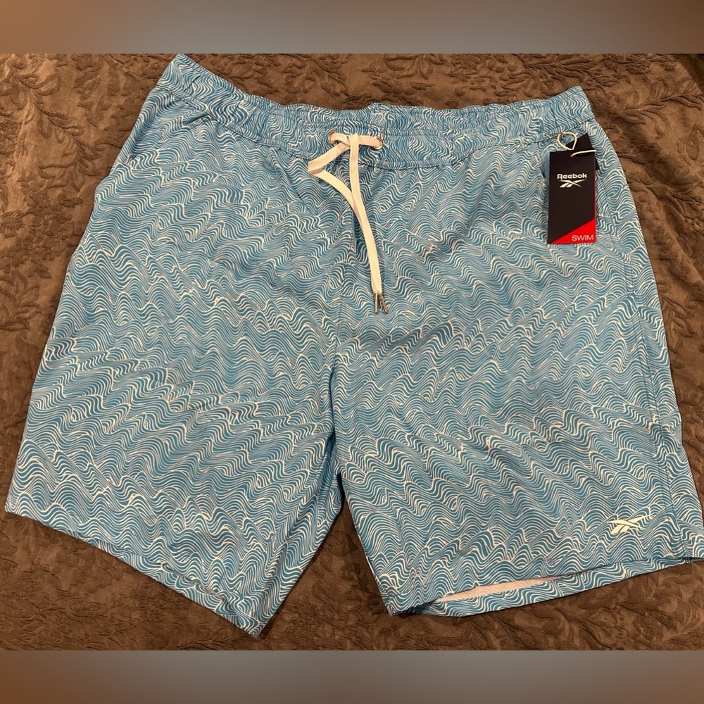 Men’s Reebok swim shorts. 9” light blue. XL. Brand new.